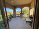 Spacious covered patio with glass top table and seating at 2321 Martinique Ave, Henderson, NV 89044