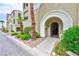 Residential building entry with arched gated entryway and landscaping at 2555 Hampton Rd # 3206, Henderson, NV 89052