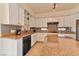 Modern kitchen with granite countertops and white cabinets at 2555 Hampton Rd # 3206, Henderson, NV 89052