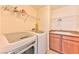 Bright laundry room with washer, dryer, utility sink and shelving at 2555 Hampton Rd # 3206, Henderson, NV 89052