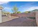 Backyard with covered patio, gravel, and a fire pit area at 2687 Hollowvale Ln, Henderson, NV 89052