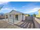 Covered patio, gravel yard, block wall, and mature trees at 2687 Hollowvale Ln, Henderson, NV 89052