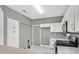 Modern kitchen with white cabinets, stainless steel appliances, and grey walls at 2687 Hollowvale Ln, Henderson, NV 89052