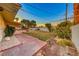 Landscaped backyard with a walkway leading to the pool and patio at 2908 Bryant Ave, Las Vegas, NV 89102