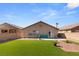 Spacious backyard with artificial turf, patio, and fire pit at 3028 Gannon Ridge Ave, North Las Vegas, NV 89081