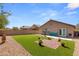 Artificial turf backyard with brick patio, and mature plants at 3028 Gannon Ridge Ave, North Las Vegas, NV 89081