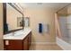 Bathroom with double vanity, large mirror, and tub shower at 3028 Gannon Ridge Ave, North Las Vegas, NV 89081