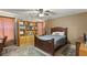 Spacious bedroom with ceiling fan, built-in shelving, and wood furniture at 3028 Gannon Ridge Ave, North Las Vegas, NV 89081