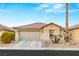 Single-story home with a two-car garage and desert landscaping at 3028 Gannon Ridge Ave, North Las Vegas, NV 89081