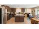 Bright kitchen featuring an island and dark brown cabinetry at 3028 Gannon Ridge Ave, North Las Vegas, NV 89081