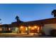 Evening view of home's exterior, highlighting its architectural details and patio at 3070 Mann St, Las Vegas, NV 89146