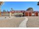 Front view of a ranch-style home with a landscaped yard and walkway at 3070 Mann St, Las Vegas, NV 89146