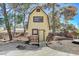 Charming yellow playhouse with a small deck and red chairs at 3070 Mann St, Las Vegas, NV 89146