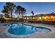 Inviting kidney-shaped pool and spa at dusk; fenced backyard at 3070 Mann St, Las Vegas, NV 89146