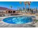 Inviting kidney-shaped pool with surrounding patio and lush landscaping at 3070 Mann St, Las Vegas, NV 89146