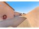 House backyard with gravel and a block wall. Hose and small gardening tools are visible at 3614 E Routt Way, Pahrump, NV 89061