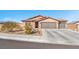 Single-story house with two-car garage and desert landscaping at 3614 E Routt Way, Pahrump, NV 89061