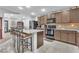 Open concept kitchen with island, granite countertops, and dark wood cabinets at 3614 E Routt Way, Pahrump, NV 89061