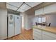 White refrigerator, wood laminate floors, and kitchen with breakfast bar at 3642 Haverhill St, Las Vegas, NV 89121