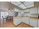 Bright kitchen with white cabinets, wood laminate flooring, and stainless steel appliances at 3642 Haverhill St, Las Vegas, NV 89121