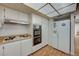 Kitchen boasts double oven, gas cooktop, and white cabinetry with wood laminate floors at 3642 Haverhill St, Las Vegas, NV 89121