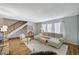 Living room with L-shaped sofa and hardwood floors, near staircase at 3642 Haverhill St, Las Vegas, NV 89121