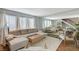 Living room with L-shaped sofa, hardwood floors, and large mirror at 3642 Haverhill St, Las Vegas, NV 89121