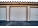 Attached garage with white roll-up door at 3791 Desert Marina Dr # 118, Laughlin, NV 89029