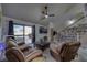 Comfortable living room featuring a entertainment center with shelving and sliding glass doors at 3791 Desert Marina Dr # 118, Laughlin, NV 89029