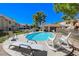 Relaxing community pool with lounge chairs and rocking chairs at 3791 Desert Marina Dr # 118, Laughlin, NV 89029