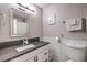 Clean bathroom with dark vanity, white tile, and updated fixtures at 3809 San Angelo Ave, Las Vegas, NV 89102