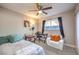 Bedroom with ceiling fan, window, and workspace at 3809 San Angelo Ave, Las Vegas, NV 89102