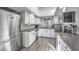 Modern kitchen with white shaker cabinets, stainless steel appliances, and gray countertops at 3809 San Angelo Ave, Las Vegas, NV 89102