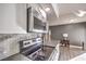 Modern kitchen with white cabinets, stainless steel appliances, and gray countertops at 3809 San Angelo Ave, Las Vegas, NV 89102