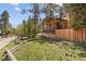 Log cabin with wooden fence and landscaping at 4187 Matterhorn Way, Mount Charleston, NV 89124