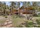 Rustic log cabin with large deck and stone pathway at 4187 Matterhorn Way, Mount Charleston, NV 89124