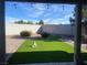 Backyard featuring artificial grass, decorative rocks, and a peaceful garden statue at 4210 Night Star St, Las Vegas, NV 89147