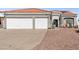 Two-story house with a three-car garage and desert landscaping at 4210 Night Star St, Las Vegas, NV 89147