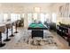 Bright game room features a billiard table under a chandelier, with a modern aesthetic at 4210 Night Star St, Las Vegas, NV 89147