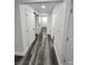 Long hallway with wood-look floors and white doors at 4231 E Kellogg Rd, Pahrump, NV 89061