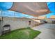 Cozy backyard with shade sail, patio, and small lawn area at 4496 Arlington Park Ct, Las Vegas, NV 89110