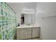 Bathroom with double sinks, a shower, and a cactus-themed curtain at 4496 Arlington Park Ct, Las Vegas, NV 89110