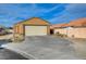 Tan house with a white garage door and a paved driveway at 4496 Arlington Park Ct, Las Vegas, NV 89110