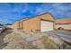 Tan house with a white garage door and a small front yard at 4496 Arlington Park Ct, Las Vegas, NV 89110