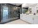 Modern bathroom with a glass-enclosed shower and double sink vanity at 5012 Notting Hill Ave, Las Vegas, NV 89139