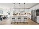 Bright kitchen with stainless steel appliances, white cabinetry, and an island with stylish pendant lighting at 5012 Notting Hill Ave, Las Vegas, NV 89139