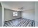 Bright bedroom with wood-look floors and ceiling fan at 5020 Valero Ct, Pahrump, NV 89060