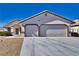 Two-story house with a two-car garage and desert landscaping at 5020 Valero Ct, Pahrump, NV 89060