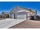 View of the house from the side, showing the two-car garage at 5020 Valero Ct, Pahrump, NV 89060