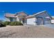 Front view of a single-story house with a two-car garage at 5020 Valero Ct, Pahrump, NV 89060